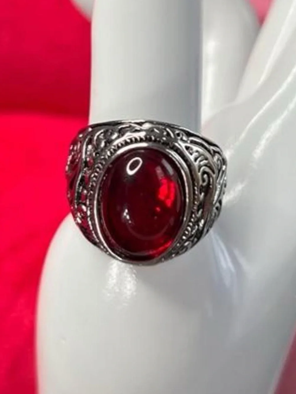 Red ruby gemstone ring with silver filigree detailing